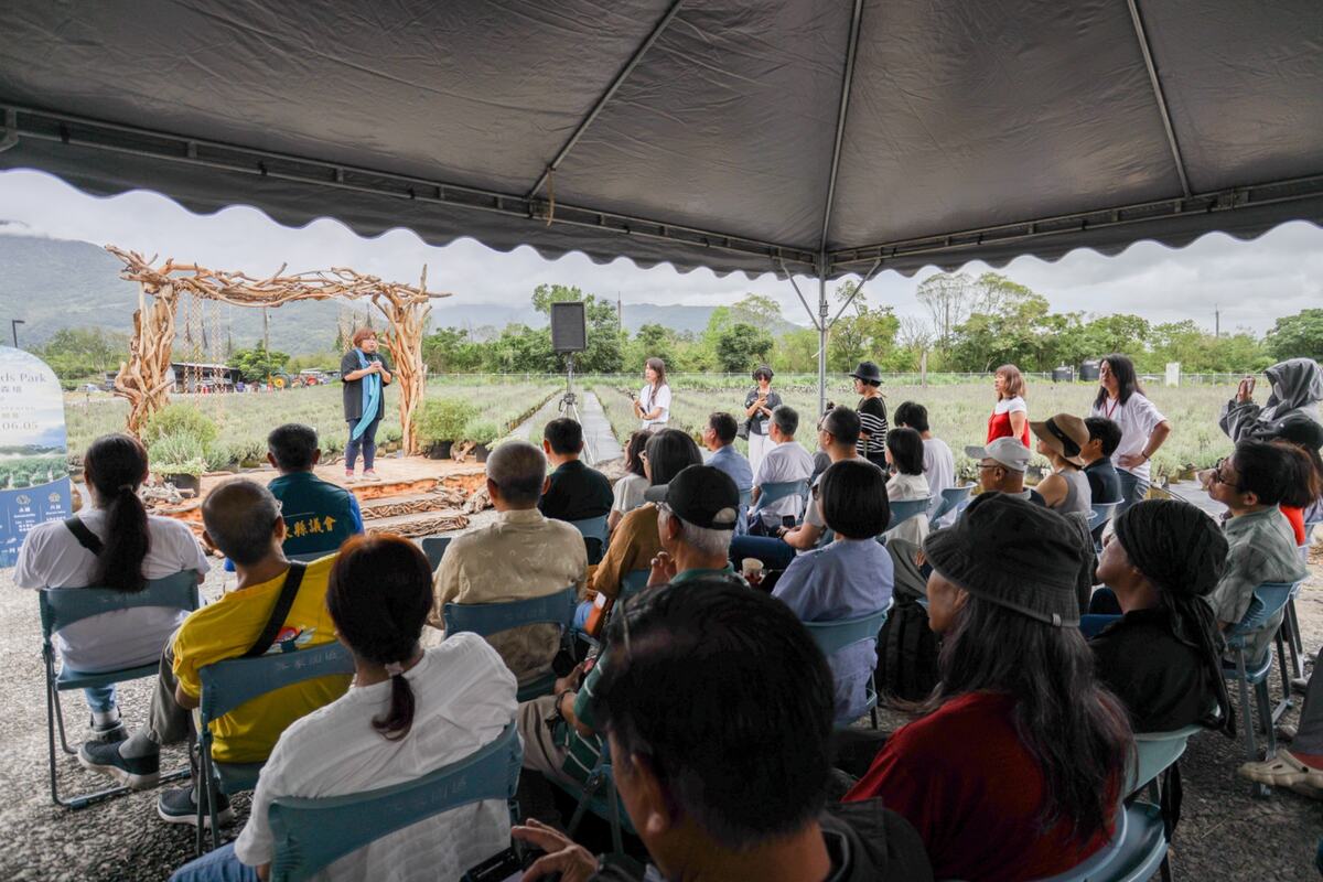 An outdoor gathering beside the lavender gardens at Blueseeds Park