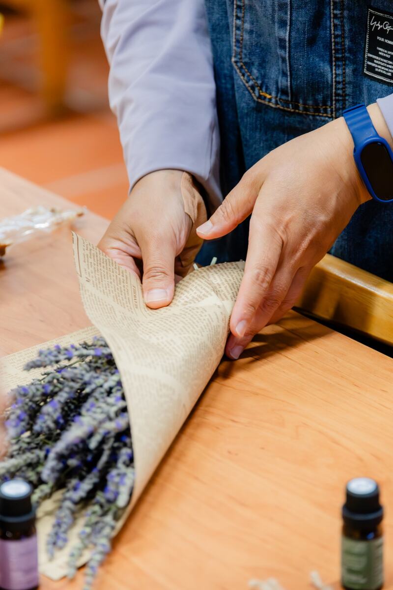 Hands arranging a lavender bouquet